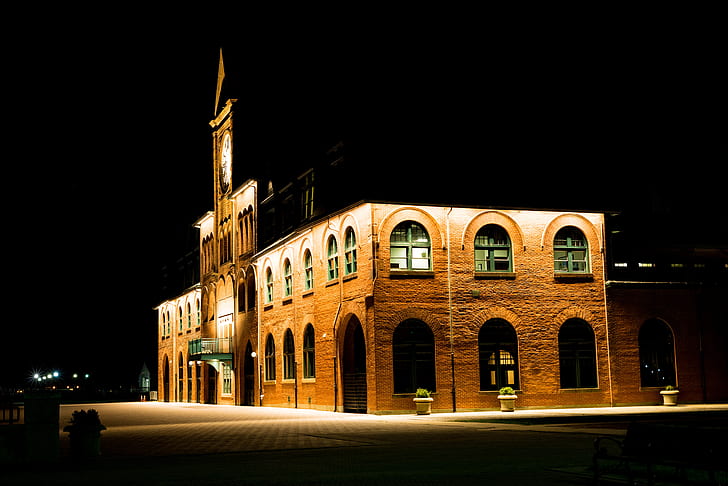 Brown Brick Building With Lights during Night Time