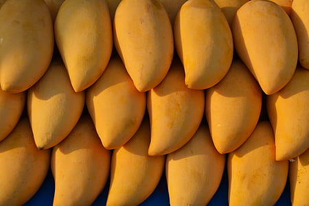 close view of three stacks of yellow mango fruit