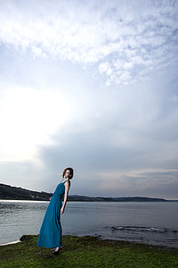 woman wearing blue sleeveless maxi dress