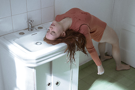 photo of bottomless woman wearing brown top in unconscious condition
