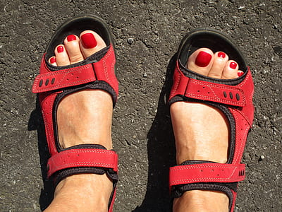 woman wearing pair of red-and-black sandals