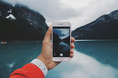 silver iphone 6 taking picture of lake during cloudy day
