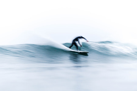 person surfing on sea wave during daytime
