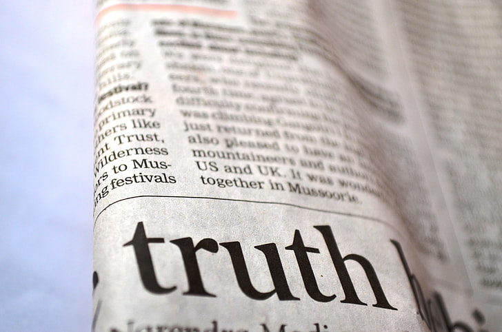 closeup photo of newspaper print showing Truth text
