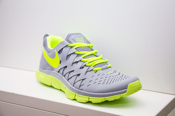 unpaired gray and green Nike running shoe