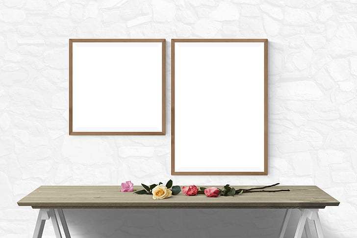 two brown wooden photo frames in front of brown wooden console table