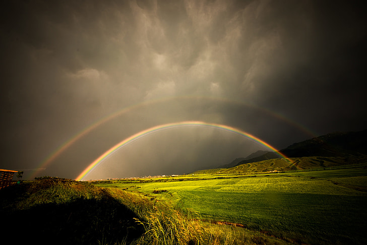 rainbow on grass field