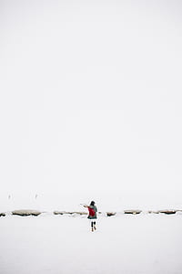 Woman Walking on Snow-covered Field