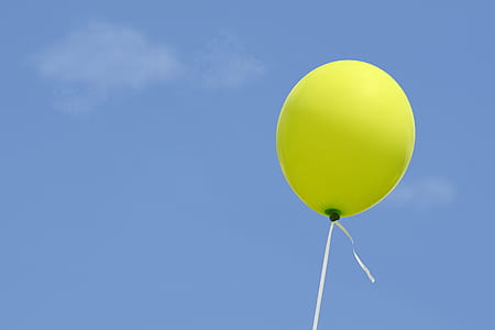 green balloon floating in the sky
