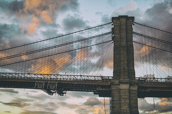 A shot of the famous Brooklyn Bridge in New York, this image was captured at sunset from Dumbo in Brooklyn