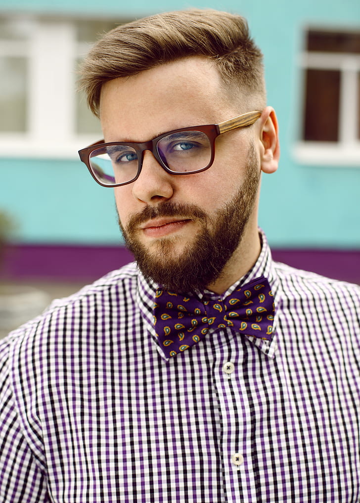 man wearing brown framed eyeglasses and purple bowtie