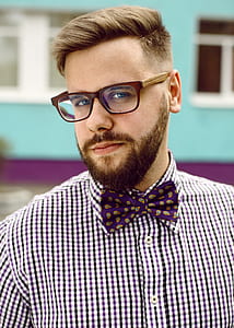 man wearing brown framed eyeglasses and purple bowtie