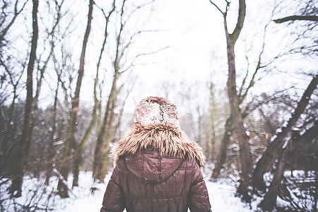 Girl Walking in Snowy Forest