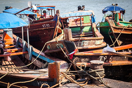two green, gray, and brown boats on seat