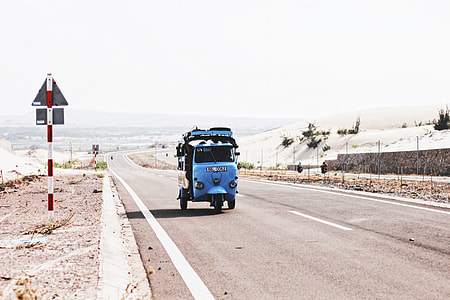 blue trike on road way during daytime