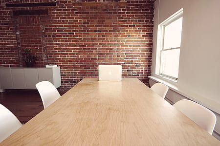 rectangular beige wooden conference table