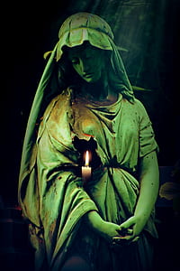 woman statue with candle wallpaper