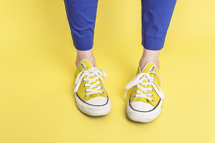 person wearing yellow Converse All Star low-top sneakers