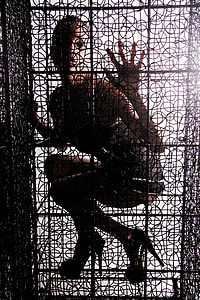 woman inside black cage
