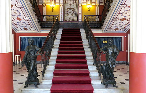 maroon carpet on white staircase