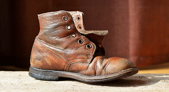 unpaired brown leather boot