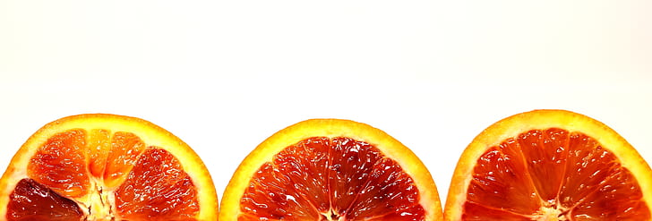 three sliced citrus fruits