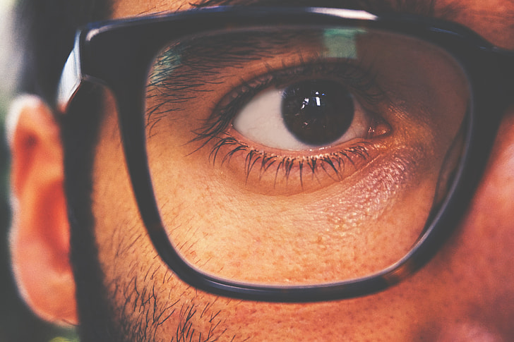 Closeup shot of a man’s eye and glasses