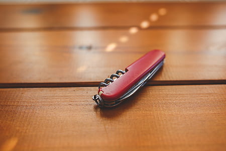Red closed penknife on the desk