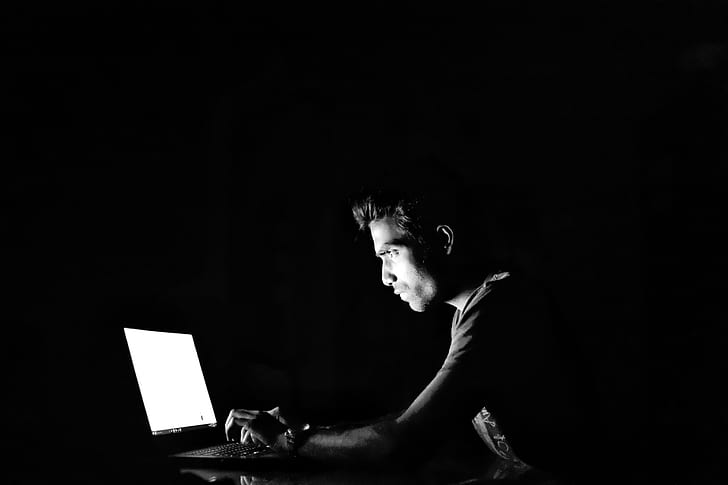 silhouette photography of man in front of turned on laptop computer