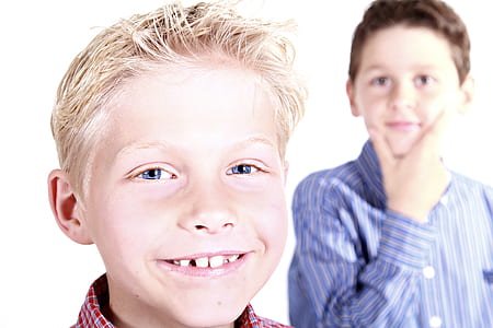 two boy wearing red and blue striped dress shirts