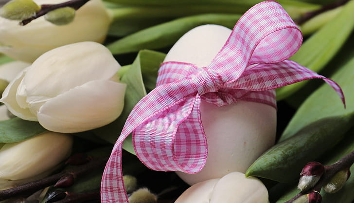 egg with bow on white lily flower