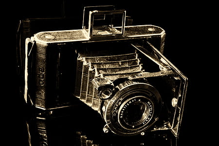 black vintage camera on black surface