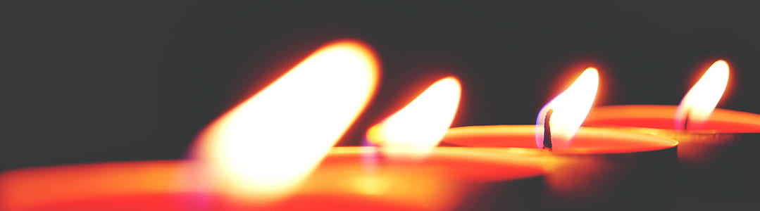 Closeup Photo of Four Tealight Candles