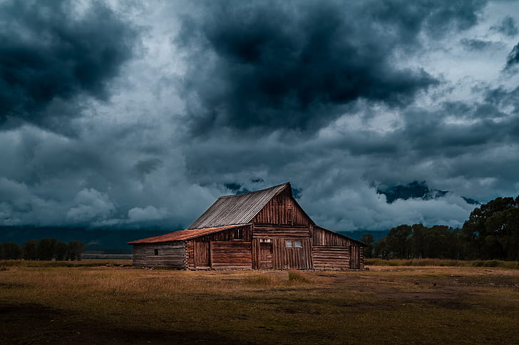 brown wooden house under cloudy sky