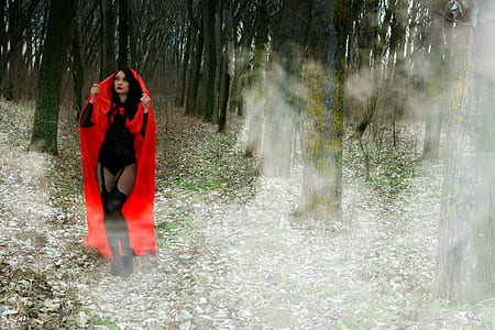 woman wearing red robe on forest