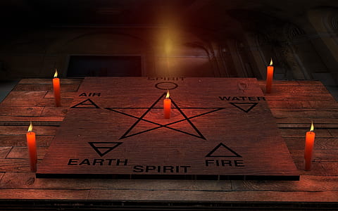 six element and star draw on board beside four candles