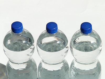 shallow photography of three clear plastic bottles