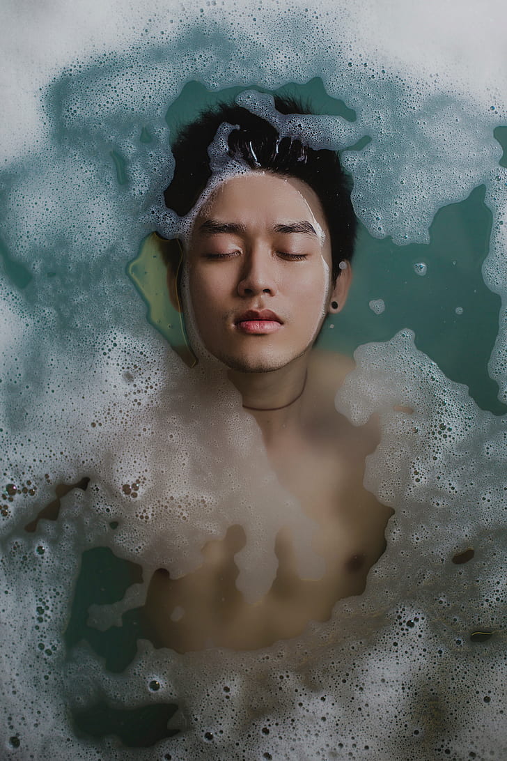 man in body of water with bubbles