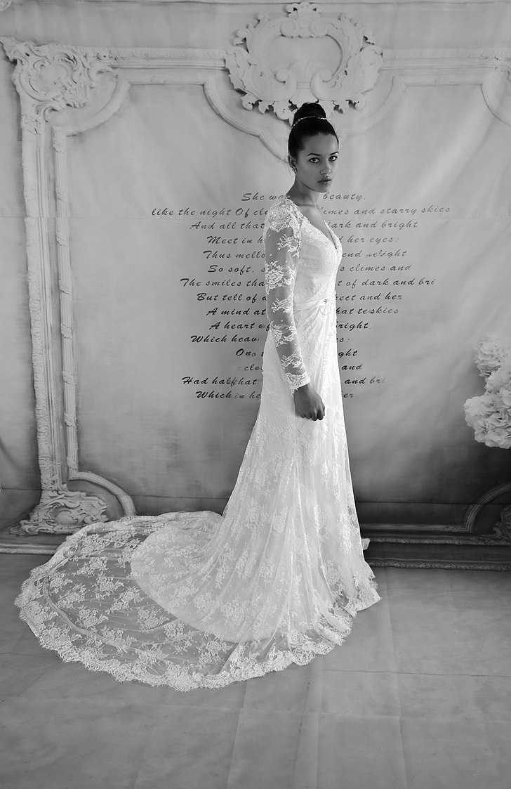 photo of woman in white floral laced long-sleeved bridal gown