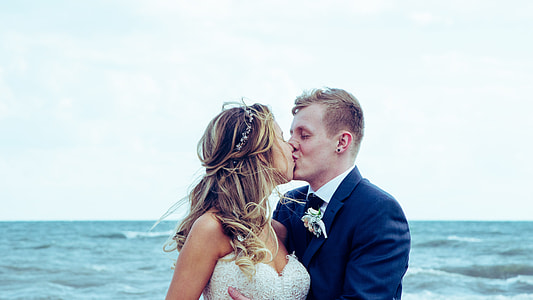 couple wedding near beach kissing during daylight photo
