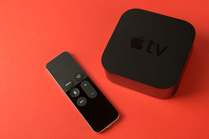 Overhead shot of the 4th generation Apple TV media player and touch remote control