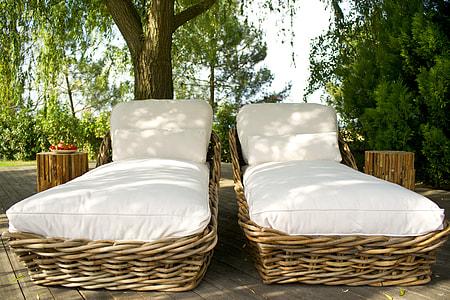 two brown wicker lounge chairs