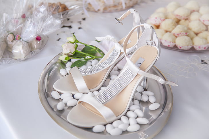 pair of white strap sandals on gray tray