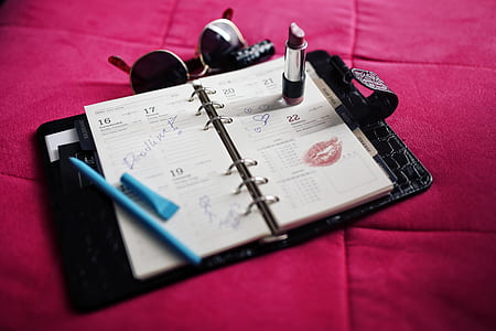 photo of black lipstick on white notebook