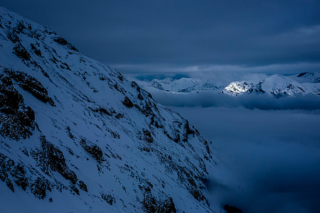 photo of snowy mountain during night time
