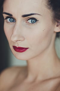 shallow focus photography of woman with red lipsticks