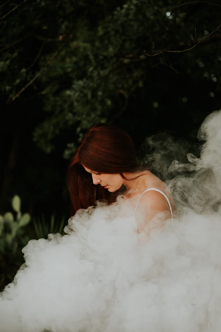 woman in white shirt with smoke