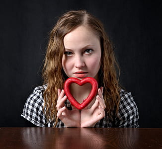 woman holding red heart decor