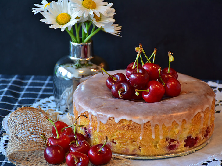 baked cake with cherry toppings