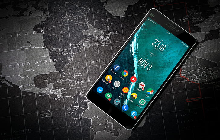 black Xioami Android smartphone on top of world map illustration
